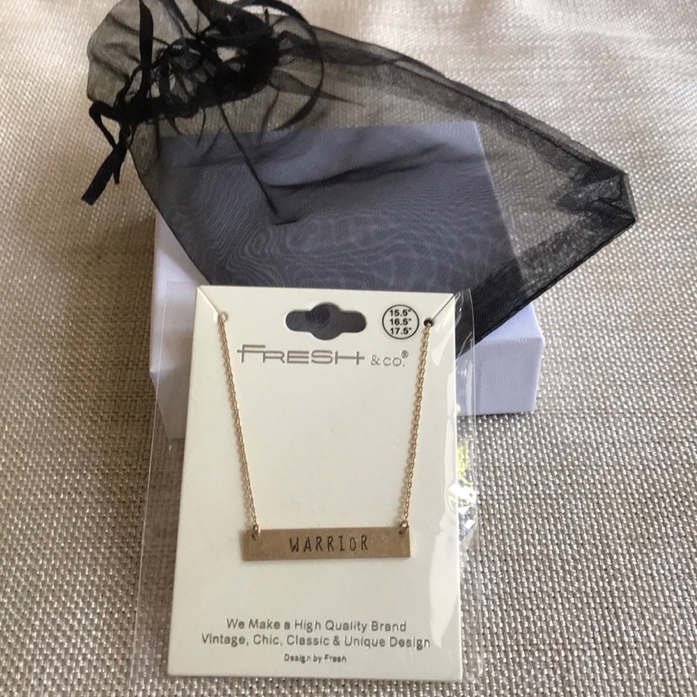 Gold metal necklace inscribed w/Warrior